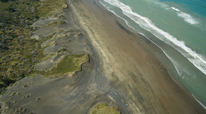 Five Mile Strip dunes with the beach and waves coming in.